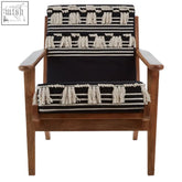 Black and white woven cefena textured lounge chair with wooden frame and tassel trim for stylish seating