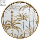 Celina botanical wall clock with gold frame white face and intricate palm tree pattern in gold and gray tones