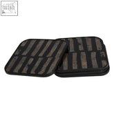 Set of four square black and gold coasters with textured horizontal stripes in gray and brown for stylish use