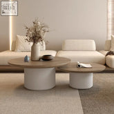 Modern round chabudai coffee table with light wood top and white cylindrical base for stylish living spaces