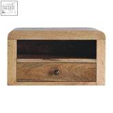 Chunky oak finish floating bedside table with light wood grain, single drawer, open shelf, and dark metal knob