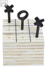 Black x and o game pieces on a striped off-white bone-inlaid tic-tac-toe board from churchill games cream and black bone noughts
