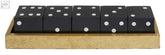 Set of five black dice with white dots neatly arranged in a textured gold tray from churchill games gold dice set