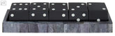 Black dice set with white dots neatly arranged in a textured gray tray by churchill games grey bone dice set