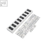 White dominoes with black pips neatly stacked in a black finish domino box by churchill games white edition