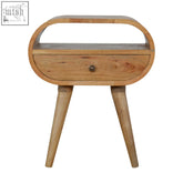 Light wood oval nightstand with single drawer and tapered legs made of mango wood featuring circular open slot design