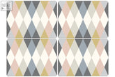 Set of four rectangular placemats with a multi coloured harlequin diamond pattern in blush pink gray and pale gold