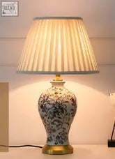 Classic ceramic lamp with white ceramic base blue floral patterns gold base and beige pleated lampshade