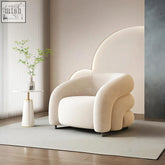 Cream-colored plush velvet classic u18 armchair with modern sculpted design and sleek black metal legs in white velvet