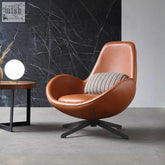 Brown leather classical snail armchair with black metal base and striped cushion for stylish comfort
