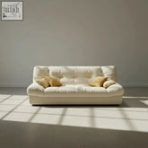 Cream-colored cloud sofa bed with premium high-density foam, soft tufted leather, and three adjustable positions with mustard pillows