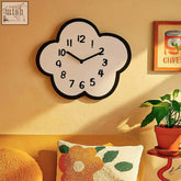 A white cloud nine clock wall clock with a black border and bold black numerals perfect for any room