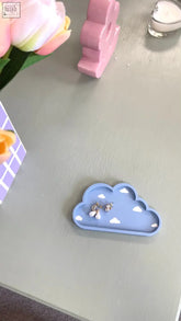 A light blue cloud-shaped trinket dish with white triangular accents perfect for holding earrings and small jewelry