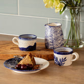 White ceramic coastal 2 espresso cups and pitcher with blue speckled glaze and hand painted botanical designs