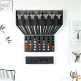 Black wall-mounted connect balls arcade game with five hoops and tray holding four balls as central piece