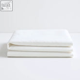 A crisp white cotton flat sheet neatly folded showcasing the cool and comfy eucalyptus silk sheets texture