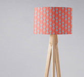 Coral and grey mid century modern retro table lamp with a coral and light blue geometric lampshade on wooden tripod base with inch diameter