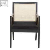Black corso rattan chair with woven cane back and seat cushion and a sleek black frame