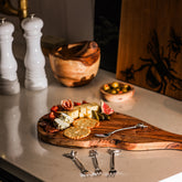 A rustic handcrafted wooden cheese board with natural grain and edges perfect for country animals pastry forks set of 4