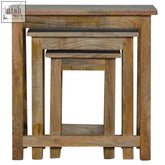 Set of three rustic solid wood stools with unique distressed finish and natural wood grain in warm earthy tones