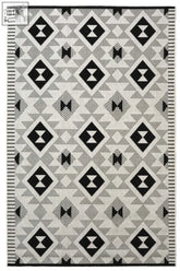 Black and white geometric patterned county geo chequer indoor outdoor rug with diamond and triangle motifs