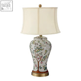 Covent Garden garden table lamp with a white ceramic body featuring pink green floral patterns and an off-white fabric shade