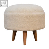 Cream boucle rounded footstool with plush sheepskin texture and solid mango wood tapered legs for cozy seating
