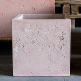A compact blushstone concrete plant pot with a rustic textured finish perfect for garden tables and greenery