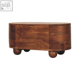 Rustic curva storage trunk with carved curved panels and warm brown wood finish on rounded ball feet