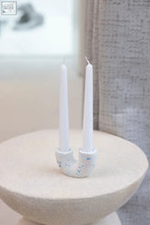 White speckled ceramic curve candle holder with two upright slots for candles perfect for cozy decor