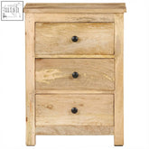 Light-colored mango wood nightstand with three drawers and black round knobs perfect as a wood bedside table