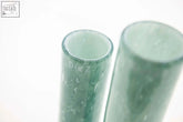 Two translucent green mouth blown glass cylinders with frosted texture from dutz collection vase range