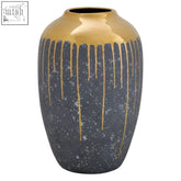 A sleek grey ceramic vase with dark speckles and gold drips from the rim cyrus grey and gold small vase