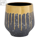A sleek modern ceramic large grey and gold finish planter with a glossy black base and gold drips cascading down sides