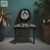 Dan gold bowler chair black upholstered with ornate white skull and floral embroidery and high density foam seat