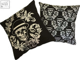 Black dan gold bowler cushions with white skull and floral patterns featuring single and repeating skull designs