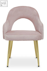 A dusky pink velvet dining chair with a curved back and gold-tone metal legs in soft velvet dining style