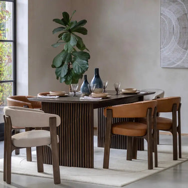 Dark wood dining table with vertical slat design and a sleek, modern aesthetic.