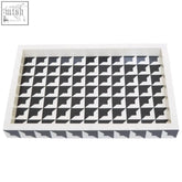 White rectangular davino black and white tray with raised edges and geometric interlocking triangle pattern
