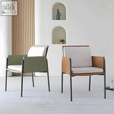 Modern decker dining chair with armrests in olive green and tan leather and white cushioned seat with black metal frame