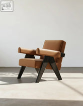 Tan leather deirdre armchair with sleek minimalist design and dark wooden legs for modern comfort and style