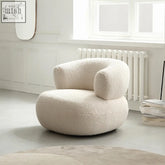 Cream-colored plush sheepskin deirdre armchair in white boucle with rounded cushioned form and cozy design