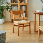 Minimalist wooden dining chair with woven natural fiber seat and backrest perfect for cozy meals