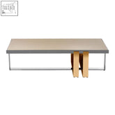 Modern rectangular demas coffee table with sleek gray top and gold toned stacked leg supports for stylish living rooms