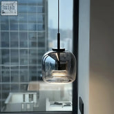 Modern smoked glass pendant lamp with sleek black metal fixture and adjustable height dildale pendant lamp