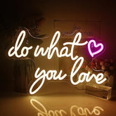 A warm white love neon sign featuring a glowing do what you love cursive script with a pink heart for wall decor