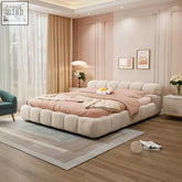 A plush beige velvet dolores tufty double bed with tufted headboard and footboard featuring gaslift storage