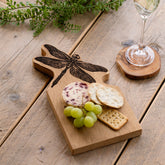 Light brown framed oak serving board with a black laser engraved dragonfly design small oak serving board