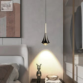 Black and gold dropping pendant light with sleek conical design and adjustable height hanging above bedside table