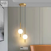 Modern style dual globe pendant light with gold tones and frosted glass bulbs for bedroom ceiling lighting